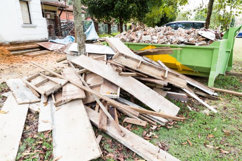 Refuse lorry and crew at commercial waste collection site