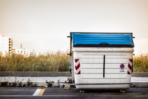 Van parked outside a Purley commercial property with workers loading waste